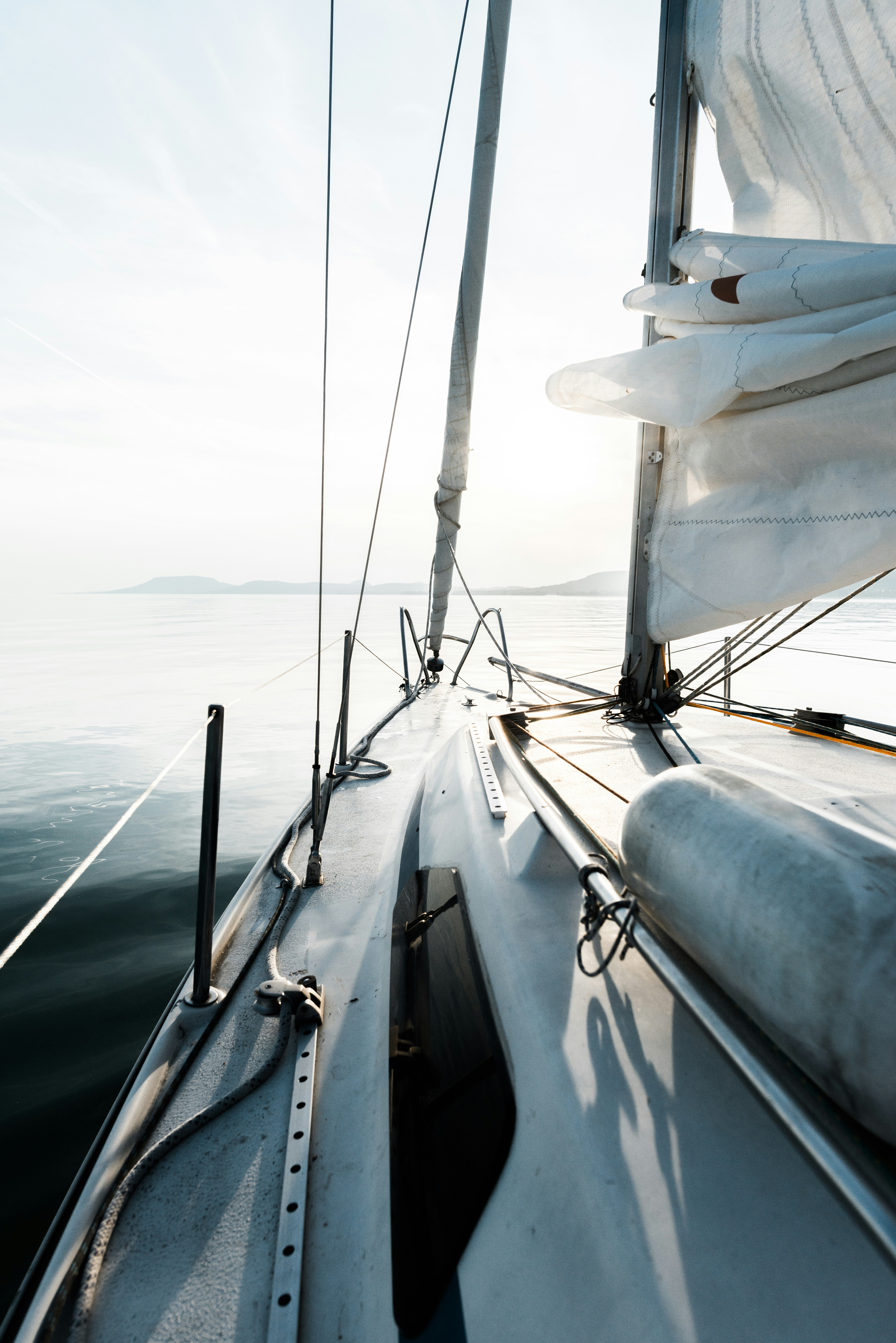 Fall boating tips: A sailboat cruising in calm water in the fall. 